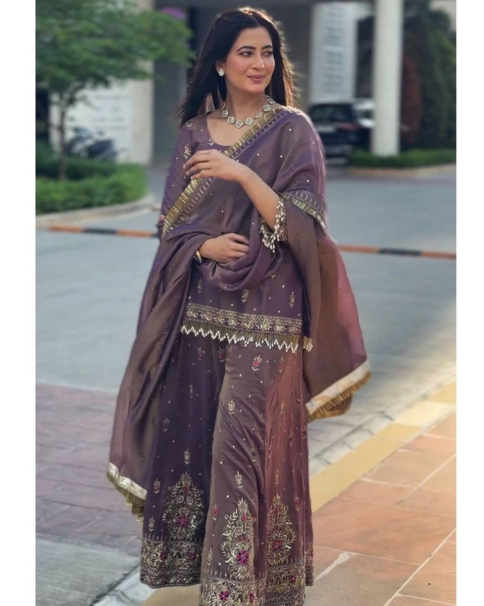 luxurious purple outfit with golden accents and floral embroidery