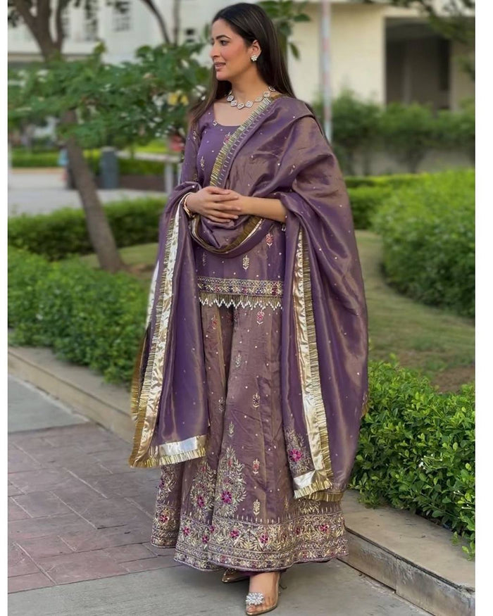 luxurious purple outfit with golden accents and floral embroidery