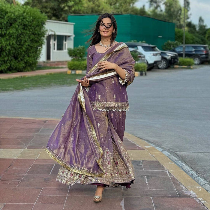 luxurious purple outfit with golden accents and floral embroidery