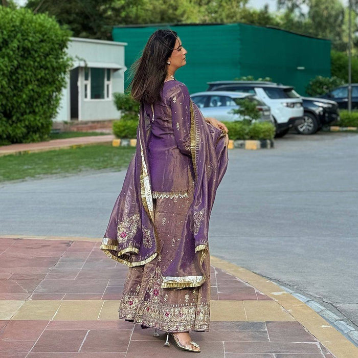 luxurious purple outfit with golden accents and floral embroidery